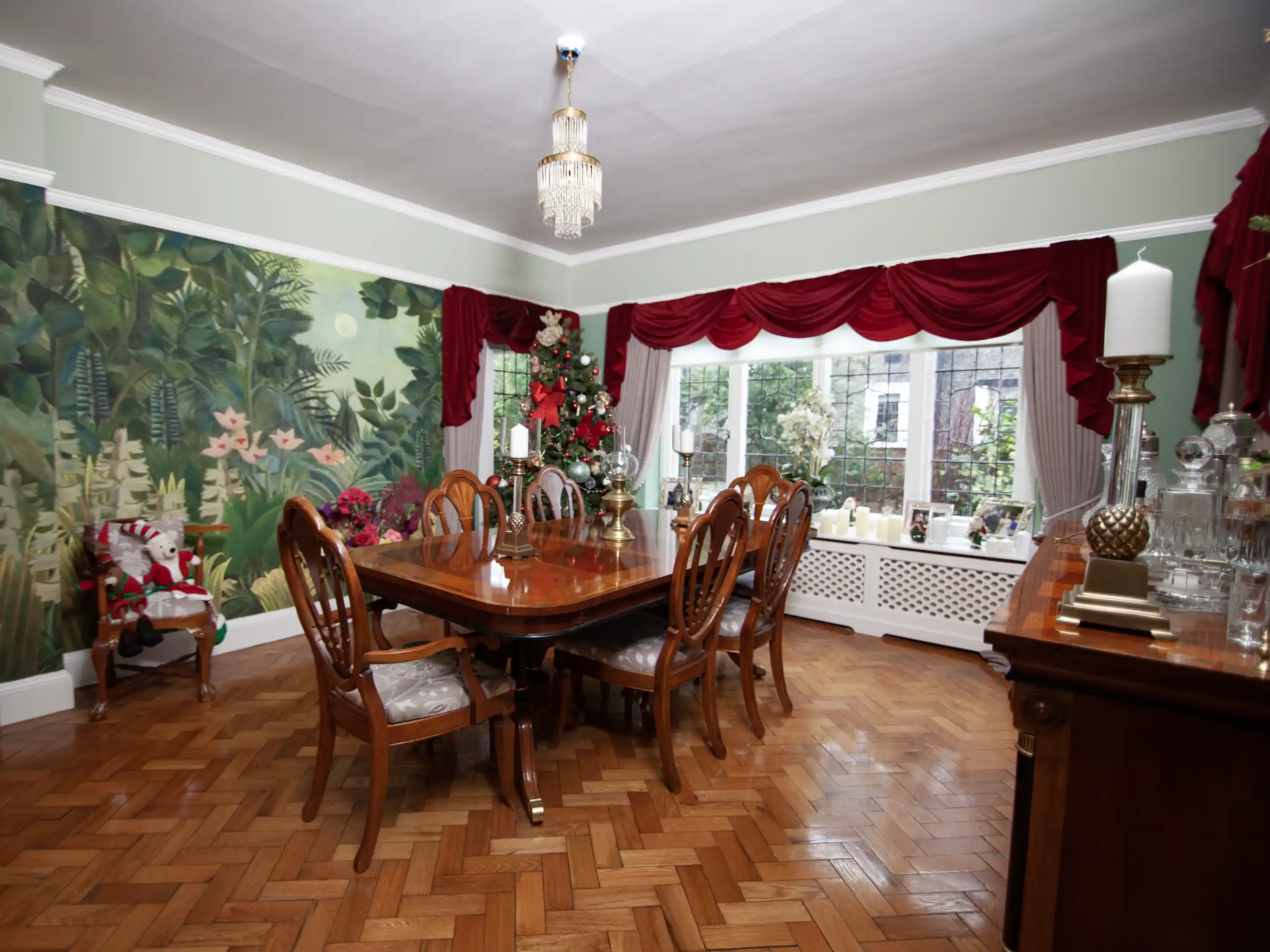 Dining room featuring bespoke green forest wallpaper from Wall and Decor in Hale, Cheshire