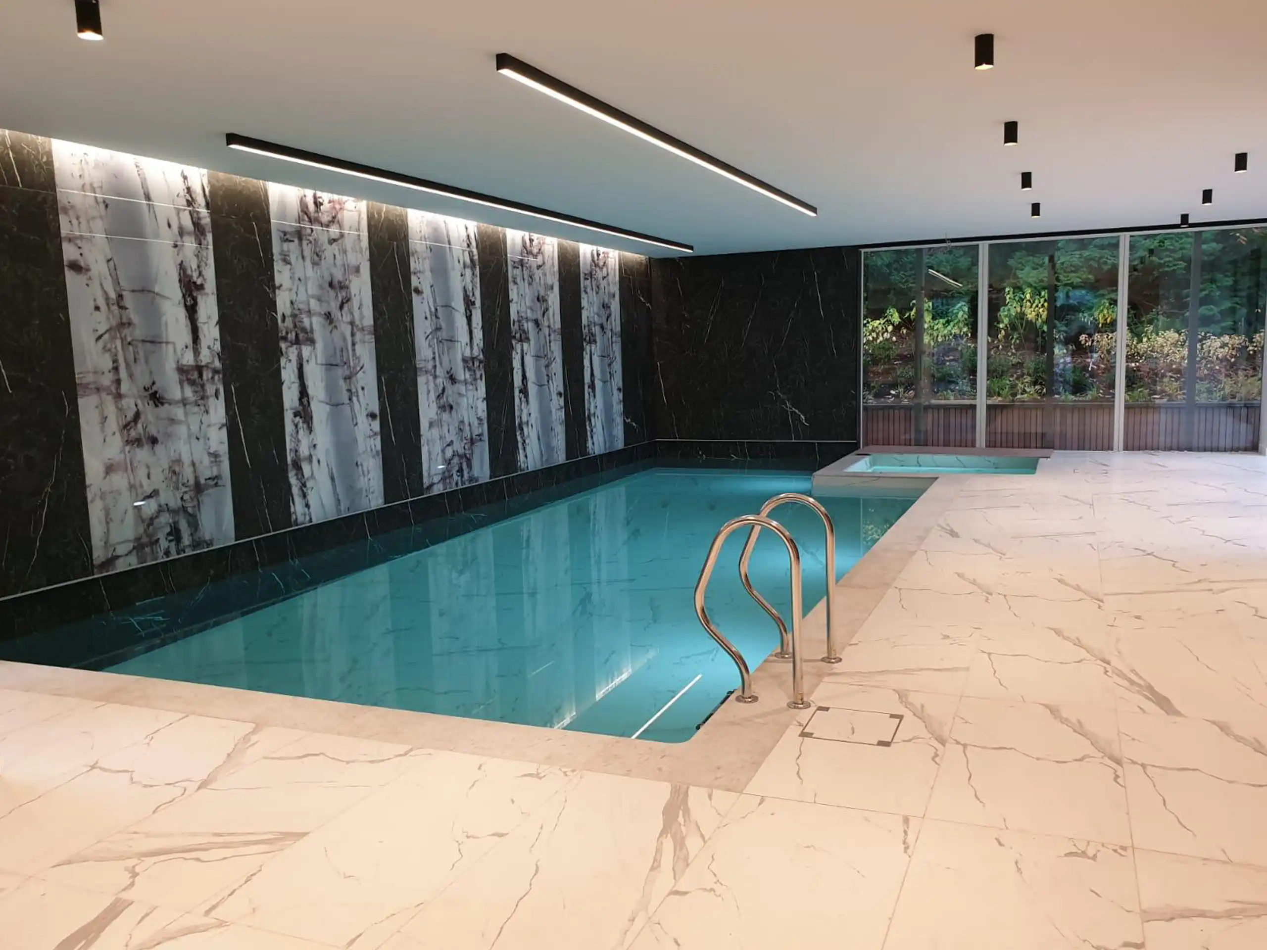 Luxury home spa with Sicis marble-effect panels and jacuzzi in Bowdon, Cheshire.