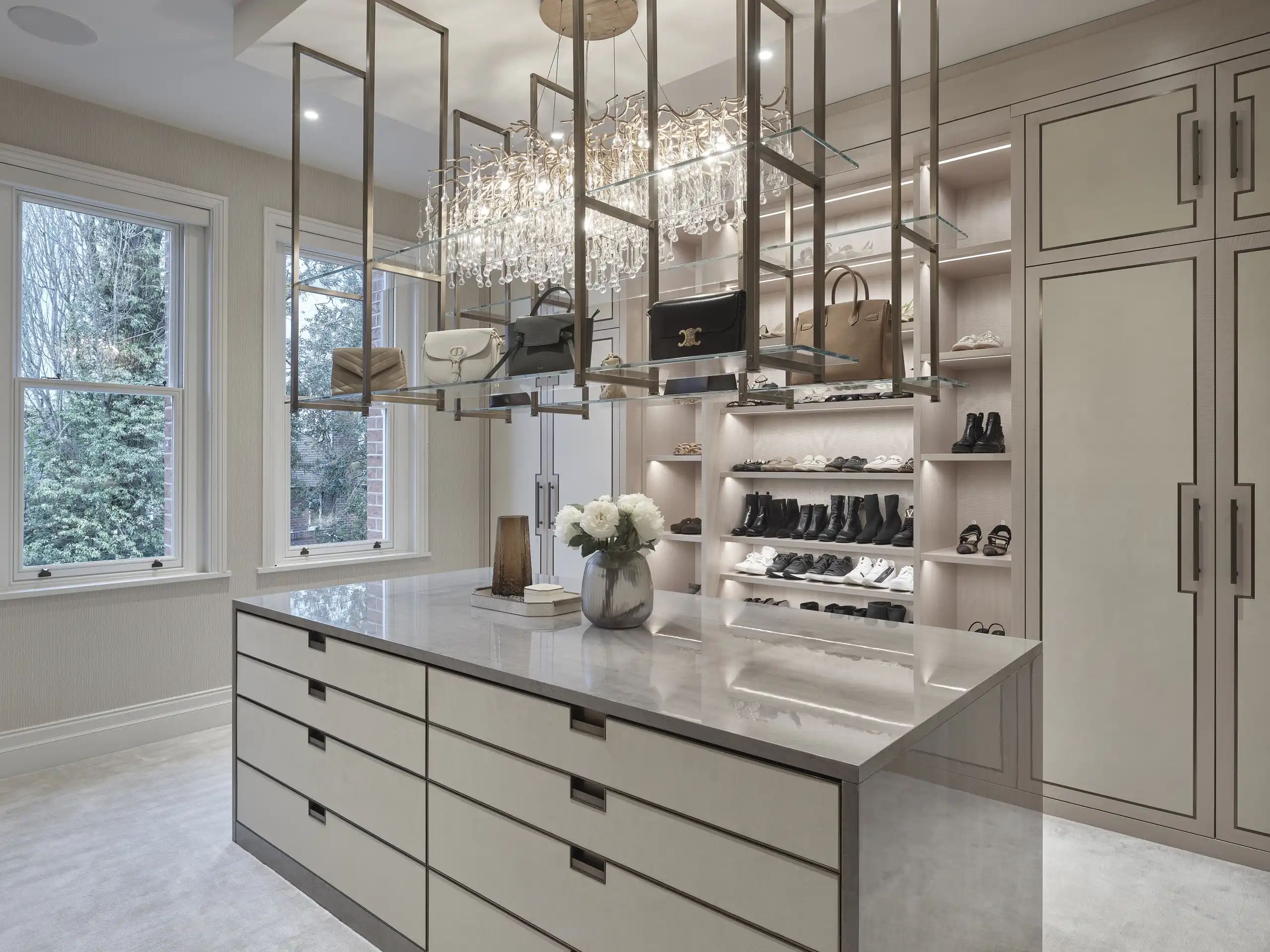 Luxurious bespoke dressing room in Wilmslow, Cheshire, with open shelving and elegant lighting design.