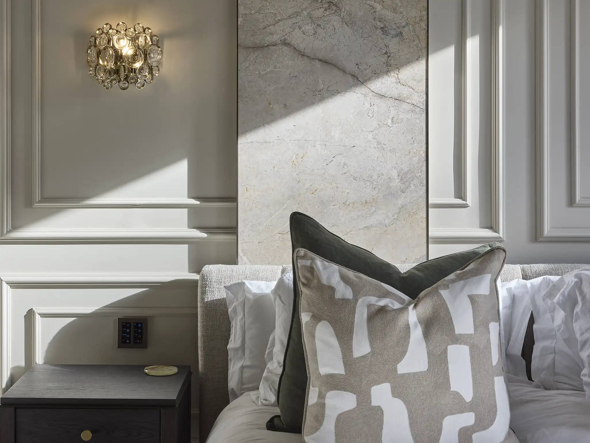 Elegant bedroom design featuring bespoke paneling, a marble accent wall, and carefully curated soft furnishings, sourced through The Space Whisperer’s procurement service.